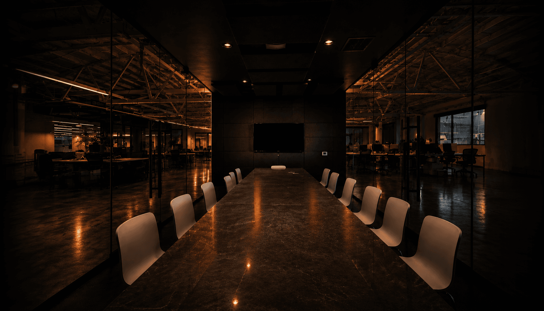 Dark conference room with a long table inside Factory HQ