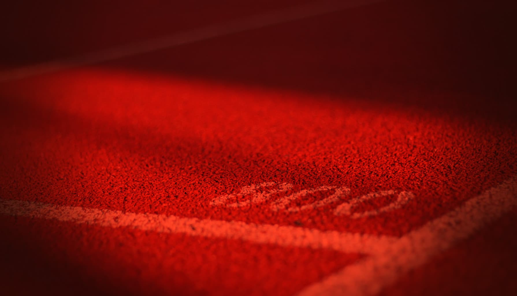 Close-up of a marked track line under red light