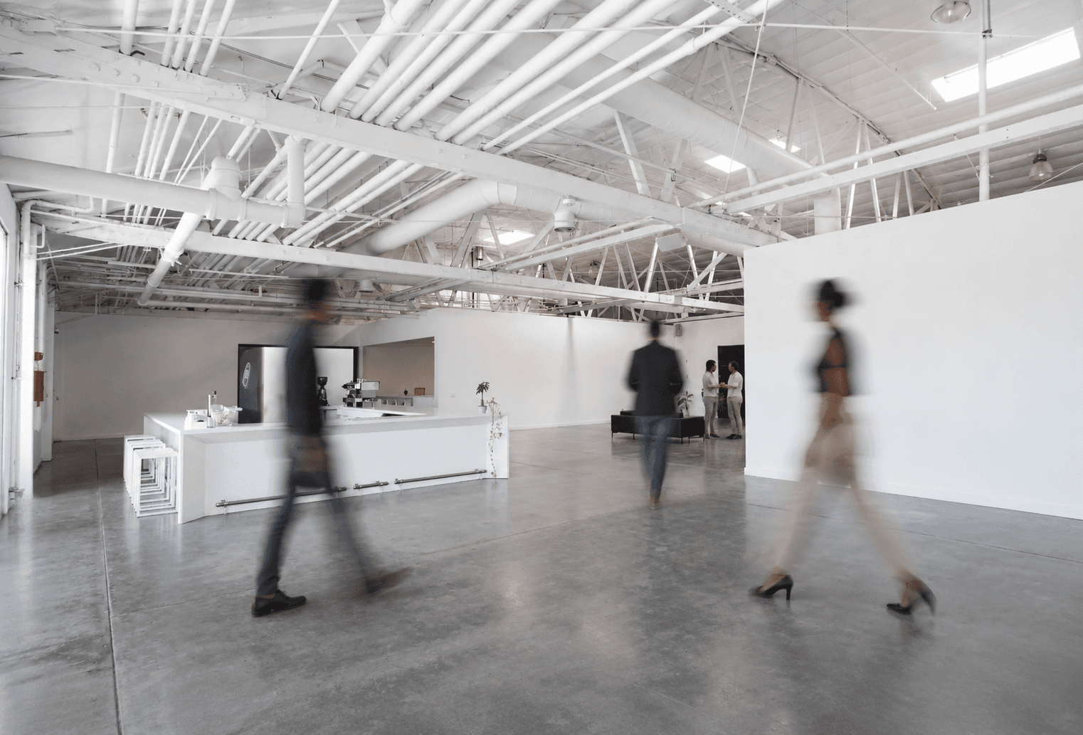 Bright Factory workspace with people moving through a polished open office